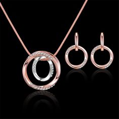 Cultivate a glitzy state of mind courtesy of this rose gold-drenched bauble set dazzling with prismatic cubic zirconia inlay. Includes pendant necklace and pair of drop earrings Necklace (chain): 15.8'' L Necklace (pendant): 0.63'' W x 0.94'' H Earrings: 1.02'' W x 1.02'' H Lobster claw clasp 18k rose gold-plated copper / silver plated copper / cubic zirconia L Necklace, Rhinestone Jewelry Set, Circle Jewelry, Loop Pendant, Color Water, Women's Jewelry Sets, Fashion Jewelry Sets, Ring Pendant Necklace, Rhinestone Jewelry