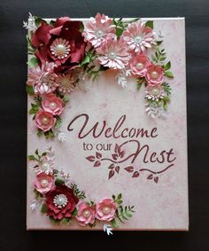 a welcome card with pink flowers and green leaves on it that says, welcome to our nest