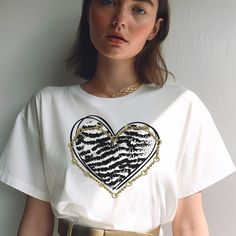 "Zebra Print Heart Shirt Retro Love Heart Shirt Gold Chain Tee Valentines Shirt Valentines Day Gift Valentine Shirt Jewelry Lover Gift Wife ♡ ITEM SPECIFICATIONS  ------------------------------------------- ❥ Stanley/Stella t-shirt - 100% organic ring-spun cotton ❥ Fabric weight: 5.3 oz/yd² (180 g/m²) ❥ Single jersey ❥ Medium fit ❥ Set-in sleeves ❥ 1 × 1 rib at collar ❥ Self-fabric neck tape ❥ Side seam construction for a structured look tailored fit that's flattering on the body. ❥ The fabric of this product is certified by GRS (Global Recycled Standard), OCS (Organic Content Standard), and GOTS (Global Organic Textile Standard) ❥The fabric of this product is OEKO-TEX Standard 100 certified and PETA-Approved Vegan ❥ Color representation is only as accurate as the web design process allows Shirt Jewelry, Three Necklaces, Steampunk Victorian, Gifts Mom, Victorian Vintage, Family Necklace, Valentine Shirt, Gift Valentine, Heart Shirt