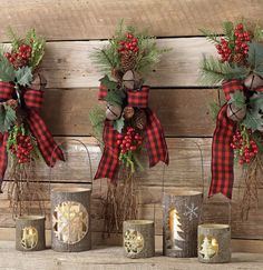 three christmas wreaths with pine cones and candles