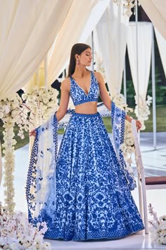 This blue lehenga set features intricate resham embroidery on softest tulle. The outfit is paired with a v-neck blouse and with a four-sided embroidered net dupatta.From Seema Gujral's Tuscan Summer collection. DELIVERY TIMEPlease allow 8-12 weeks for your outfit to arrive. FABRIC DETAILSNet Professional cleaning only. Latest Lehenga Designs, Seema Gujral, Resham Embroidery, Trendy Outfits Indian, Indian Outfits Lehenga, Wedding Lehenga Designs, Resham Work, Work Lehenga, Blue Lehenga