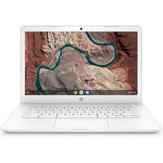 an open laptop computer sitting on top of a white table next to a desert landscape