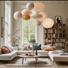 a living room filled with furniture and lots of lights hanging from it's ceiling