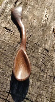 a wooden spoon sitting on top of a piece of wood