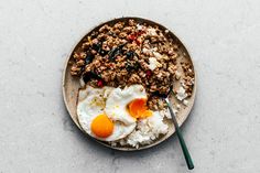 an egg, meat and rice dish on a plate