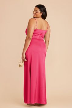 a woman in a bright pink dress is looking back at the camera and she has her hand on her hip