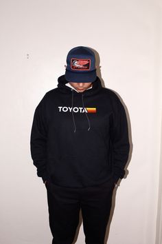 Classic Toyota on a black hoodie or tee. ~ Retro vibes ~ Made to order. Hooded T-shirt For Fall Streetwear, Hooded Winter Streetwear T-shirt, Hooded T-shirt For Streetwear In Fall, Casual Hooded T-shirt With Logo Print, Sporty Hooded T-shirt For Streetwear, Hooded Cotton T-shirt For Streetwear, Cotton Hooded T-shirt For Streetwear, Black Band Merch Hoodie With Logo Print, Casual Pre-shrunk Hooded T-shirt