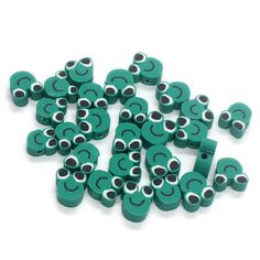 a pile of green and black eyeballs on a white background