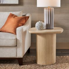 a living room scene with focus on the end table and chair, which has a lamp on it