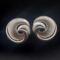 These vintage Trifari clip on earrings feature brushed silver tone swirls and measure 1" D. They are signed with the crown Trifari mark on the clip on closure. Retro Silver Clip-on Earrings For Wedding, Silver Retro Clip-on Earrings For Wedding, Retro Silver Metal Clip-on Earrings, Silver Retro Metal Clip-on Earrings, Vintage Trifari, Crown Trifari, Kingston, The Crown, Vintage Signs