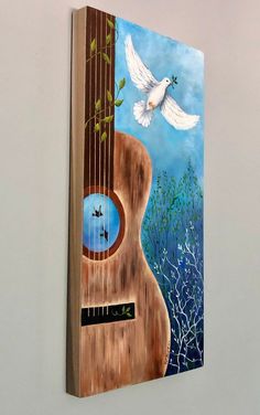 a painting of a guitar with a dove flying over it