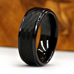 a black wedding ring with an elegant design