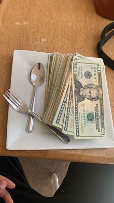 a fork, knife and money on a plate