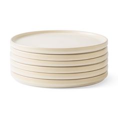 six white plates stacked on top of each other