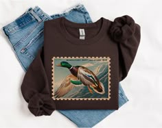 Duck hunting, duck hunter, duck hunter girlfriend, duck hunter wife, duck season, hunting wife, oversized boyfriend, hunting season, retro crewneck, vintage crewneck, gifts for duck hunter Ideal for any situation, a unisex heavy blend crewneck sweatshirt is pure comfort. These garments are made from polyester and cotton. This combination helps designs come out looking fresh and beautiful. The collar is ribbed knit, so it retains its shape even after washing. There are no itchy side seams on these sweaters.  .: Made with a medium-heavy fabric blend of 50% cotton and 50% polyester (8.0 oz/yd² (271.25 g/m this sweatshirt feels cozy and is the perfect choice for those colder months. .: The classic fit along with the crew neckline deliver a comfy wearing experience with a clean-cut style. Meanw Clothes For Boyfriend, Duck Clothing, Duck Sweater, Retro Crewneck, Duck Stamp, Boyfriend Sweatshirt, Duck Season, Duck Hunter, Crewneck Vintage