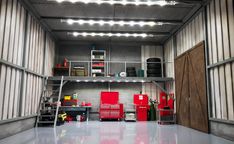 the inside of a storage room with lights and tools