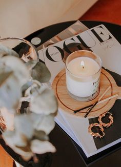 an open magazine with a candle on it