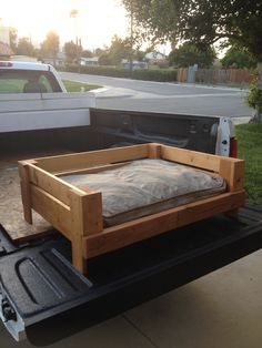 a bed sitting in the back of a pickup truck on top of a flatbed