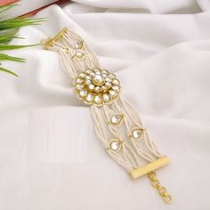 Kundan Pearl Chain bracelet/ Indian Kundan Bracelet / Indian Pearl Statement bracelet/ Kundan bracelet/ Gold plated Indian Bridal Bracelet Features Traditional Kundan/Pearls bracelet Handcrafted To Perfection Light Weight Perfect For Indian Weddings And Celebrations A Beautiful & Memorable Gift for Weddings and Special Occasions Available in size 2.6,2.8,2.10 Facebook: www.facebook.com/shoparyafashions Pinterest: www.pinterest.com/aryafashions Instagram: www.instagram.com/shoparyafashions Twitte Adjustable Metal Bracelet For Celebration, Adjustable Metal Bracelets For Celebration, Adjustable White Pearl Bracelet For Festive Occasions, Festive Adjustable White Pearl Bracelet, Beaded Bracelet Jewelry For Celebration, Traditional White Metal Bracelet, White Bangle Bracelets For Festive Occasions, Festive White Bangle Bracelets, White Bracelets For Party And Festivals