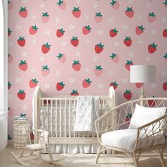 a baby's room with pink wallpaper and white rocking chair in front of the crib