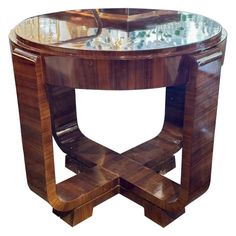 a wooden table with glass top and curved legs