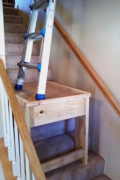 there is a ladder going up to the top of this stair case on the stairs