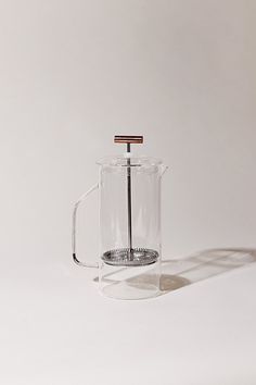 a glass coffee pot with a wooden handle