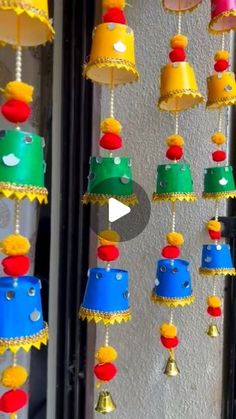 colorful bells hanging from the side of a building