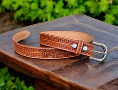 ➤Fully handmade western cowboy leather belt ➤ Stainless Steel Buckle ➤Tooled embossed design ➤Custom engraving option ➤ Single Piece Leather ➤100% full grain genuine leather ➤ Easy Snap System for Interchanging Buckles ➤ 1.5" WIDE ➤Belt thickness 3.2 mm - 1/8" thickness ➤Returns accepted within 30 days of receiving item (custom engraved beltscannot be returned) Tooled Western Floral Engraved Leather Belt for Men 100% Genuine Full Grain Cowhide with Snaps 1-1/2" WIDE Personalized Belt that serves as a great gift for your loved one. You can choose to personalize this belt, making it an Engraved Belt. This is a handmade western leather belt. Belt Making, Custom Leather Belts, Belt With Buckle, Belt For Men, Rodeo Cowboy, Embossed Design, Western Leather, Wide Belt, Leather Belts