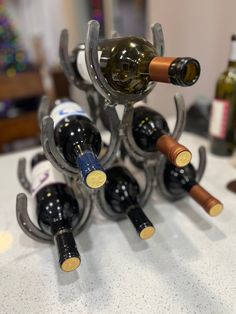 several bottles of wine are stacked up on a table