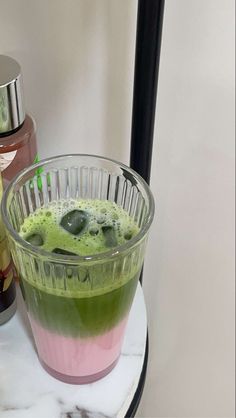 a drink sitting on top of a table next to a blender