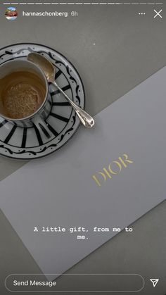 a cup of tea sitting on top of a white plate next to a piece of paper