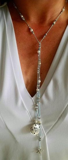 Always bring a reminder of the ocean with you. This silk, hand knotted lariat has two beautiful focal pieces, a starfish and sand dollar. Surrounding them are crystals and fresh water pearls. The lariat is created on light blue silk. Each lariat is created upon order. There may be slight variations in the beads. This lariat does not have a clasp. Simply criss cross and flip one end over to make a Y and complete the necklace. Once worn, lariats look beautiful and do not tangle. You can accomplish different looks by criss crossing in different places.  The necklace measures 34 inches.  Each piece comes with a card that says "Created especially for you." (photo 2) If you would prefer a different card, please look at the listing for cards to choose one that suits your needs. Include the card c Sterling Silver Lariat Necklace, Aunt Necklace, Silver Lariat Necklace, Godmother Necklace, Lariat Necklace Silver, Initial Necklace Silver, Pearl Lariat, Hand Knotted Necklace, Heart Anklet