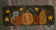 a rug with pumpkins and cats on it