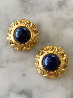 AMAZING VINTAGE 1980s LARGE CLIP-ON EARRINGS.  Unique blue centre with ornate gold detail.  In great condition! 1950s Casual Jewelry, Blue Metal Clip-on Earrings, Vintage Blue Brass Earrings, Vintage Blue Clip-on Jewelry, Vintage Blue Clip-on Earrings For Evening, Vintage Blue Earrings For Formal Occasion, Vintage Blue Earrings For Evening, Vintage Blue Clip-on Earrings, Blue Vintage Earrings For Formal Occasions