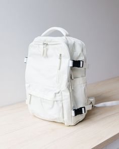 A large white backpack designed to meet all your travel needs with its spacious and functional features. This backpack boasts a solid khaki color, offering a versatile and timeless look that complements any outfit or style. Crafted from durable nylon material, this backpack is built to withstand the rigors of travel and everyday use. The sturdy construction ensures longevity and durability, making it the perfect companion for your adventures. Equipped with a secure zipper closure, this backpack White Casual Travel Bag With Zipper Closure, Casual White Travel Bag With Zipper Closure, White Large Capacity Backpack For Outdoor, White Large Capacity Travel Bag For School, White Backpack With Zipper Closure For Outdoor, Large Capacity White Travel Bag For School, Functional White Travel Bag With Adjustable Strap, White Backpack With Zipper For Outdoor Activities, White Standard Backpack For Outdoor