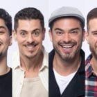 four men are smiling and posing for the camera with different facial expressions on their faces