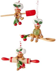 three christmas ornaments hanging from wooden spoons