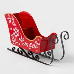 a red and gold sleigh with snowflakes on the sides is shown