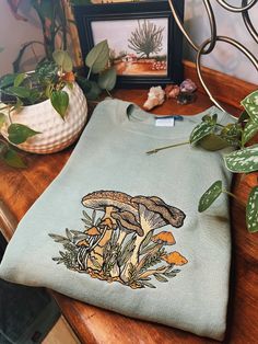 Sage Fungi Foliage Embroidered Crewneck Unisex Embroidered - Etsy Cotton Fall Sweatshirt With Mushroom Print, Cotton Sweatshirt With Mushroom Print For Fall, Winter Cotton Tops With Mushroom Print, Earthcore Aesthetic, Goblincore Cottage, Goblincore Outfits, Current Aesthetic, Cottagecore Indie, Teen Outfits