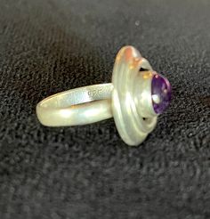 "1960's Artisan Modernist Concentric Circles Ring, Sterling Silver w Round Amethyst Cabochon, Good VTG Cond., Some Scuffs on gem, S9, 3/4\"W. Could be worn as an \"Evil Eye\" protection. c.1960's Please read all descriptions and view all photos carefully. Please feel free to ask any questions that are not addressed on my policy page or in above description. I am happy to help. Thank you for wandering around my shop. I hope you enjoyed your visit and come back often, as I am continuously adding n Evil Eye Protection, Concentric Circles, Amethyst Gem, Circle Ring, Family Event, Purple Band, Eye Protection, Ring Sterling Silver, Evil Eye