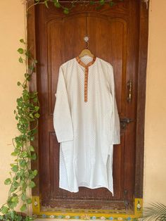 pure silk paithani mens kurta/mens kurta set/cream mens kurta /white mens kurta/Indian mens wear/chikankari kurta/groom wedding indian kurta/cream wedding kurta/paithani kurta     Well..!! we understand that you may not get in your desired size/pattern, here you go with customization according to your size/pattern which we can deliver in 1-2 weeks of time period !!      Here is a beautiful chikankari mens kurta with paithani border highlights as shown !!this Kurtas can be customized in colors and patterns and sizes !! comes with matching pants!!Please message us for any customization !!  Fabric : pure chikankari silk ( design may vary acc to availability ) Lining : no  Closure : front open with buttons  kurta length: 45 inch approximately       please note that the item might ships from US Festival Mulmul Kurta With Naqshi Detail, Naqshi Cotton Straight Kurta, Mulmul Kurta With Naqshi For Festivals, Traditional Cotton Silk Tunic Kurta, Cotton Straight Kurta For Wedding, White Mulmul Kurta With Naqshi Detailing, Off White Straight Kurta, White Long Sleeve Handloom Traditional Wear, Traditional White Kurta Tunic