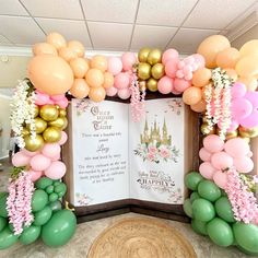 an open book surrounded by balloons and flowers