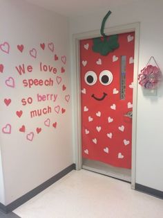 a door decorated to look like a strawberry with the words we love speech so berry much