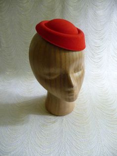 "Molded faux felt pillbox style fascinator hat base in pretty lipstick red that measures 6.5\" x 5.5\" - and has a contoured shape to fit on the head. Low side is approximately .75\" and the higher side is approximately 1.5\". Just attach an alligator clip inside or an elastic to make this a breeze to wear. A cute little base ready for your next DIY millinery project. Easy to decorate with many of the flowers and leaves available in my shop! (PLEASE NOTE this is a FASCINATOR SIZE HAT BASE not a Red Adjustable Hat With Round Crown, Red Adjustable Round Crown Hat, Red Adjustable Hat, Fitted Formal Flat Cap Felt Hat, Red Fitted Mini Hats For Winter, Red Fitted Vintage Top Hat, Adjustable Red Brimmed Fascinator, Adjustable Brimmed Red Fascinator, Red Adjustable Brimmed Fascinator