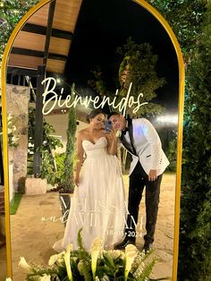 a bride and groom standing in front of a mirror with the words beverends written on it