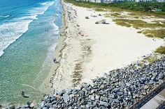 an aerial view of the beach and ocean