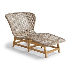 a chair that is made out of wood and wicker with a cushion on it