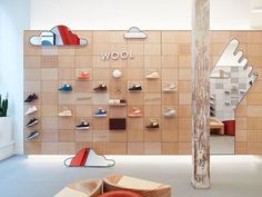 the interior of a shoe store with wooden shelves