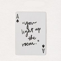 a playing card with the words you light up the room written in black on it